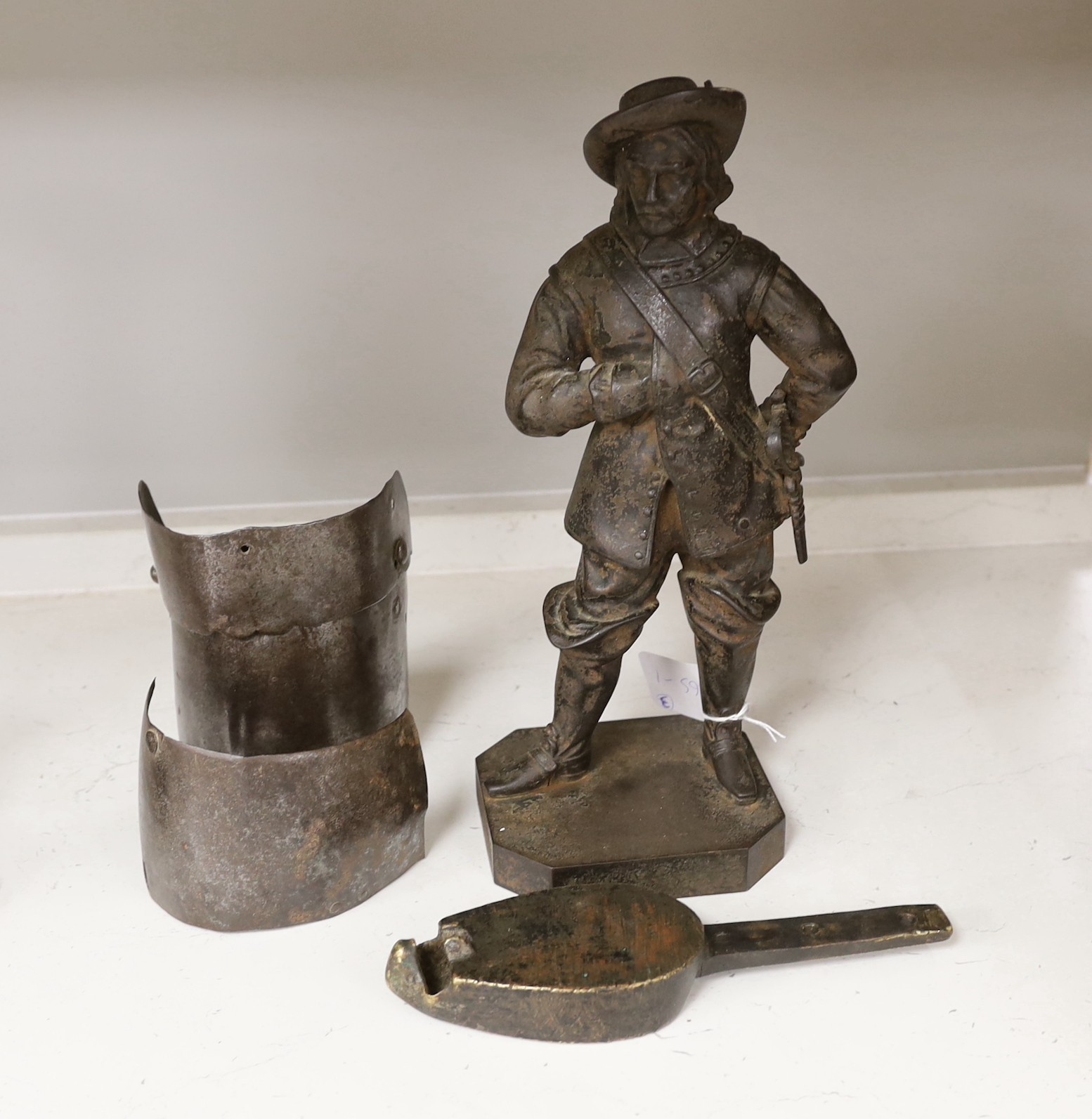 Two 17th century armour parts, together with a cast iron statue of Oliver Cromwell and southern Italian bronze oil lamp. Tallest 32cm